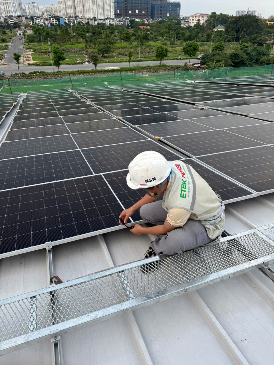 Engineers installing rooftop solar panels at a factory in Vietnam